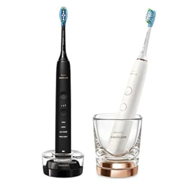Abbildung von Philips Sonicare DiamondClean 9000 elektrische Zahnbürste, Schallzahnbürste mit App, Andruckkontrolle, 4 Putzmodi, 3 Intensitätsstufen, Ladeglas, Schwarz und Roségold, Zweierpack, Modell HX9914/57