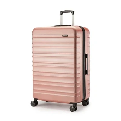 Abbildung von Amazon Basics Hartschalenkoffer, Großer Koffer (78 cm), Kratzfeste ABS Schale, Erweiterbar, 4 Rollen, Roségold